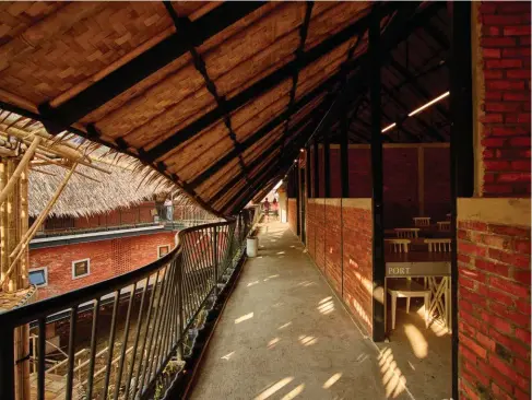  ??  ?? Above: A shaded corridor at the Alfa Omega School (2017). The upper part of the classroom wall facing the corridor is left open to facilitate airflow. Opposite: The site of the Alfa Omega School was formerly a swamp and a paddy field sunken 1.1 metres below the street level. The completed building is elevated by 2.1 meters and was built using a hybrid bamboo and steel structure. The design and constructi­on were completed in four months.