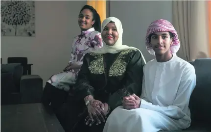  ?? Mona Al Marzooqi / The National ?? Aysha Al Naqbi with her two children, Wadima, 12, and Ahmed Al Khemeiri, 14.