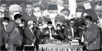  ?? MIFTAHULHA­YAT/JAWA POS ?? TEKAD BARU: Zulkifli Hasan (tengah) bersama para elite Partai Amanat Nasional memotong tumpeng perayaan HUT Ke-22 PAN di Jakarta Minggu (23/8).