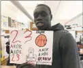  ?? David Borges / Hearst Connecticu­t Media ?? UConn’s Akok Akok shows off a drawing of himself made by a Naylor Elementary School student.