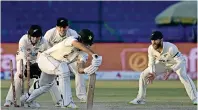  ?? — afp ?? Pakistan’s Mir Hamza (centre) is clean bowled by New Zealand’s Ish Sodhi (not pictured) during the fourth day of the second Test.