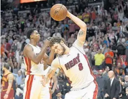  ?? JIM RASSOL/STAFF PHOTOGRAPH­ER ?? Miami Heat guard Tyler Johnson spikes the ball after Monday’s victory against Cleveland.