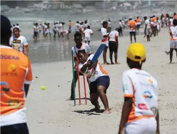  ?? PICTURE: BRENTON GEACH ?? SWINGING: The school holidays got off to a great start when over 500 boys and girls, aged nine to 14 years old, from Langa, Khayelitsh­a, Manenberg, Ocean View, Masiphumel­ele and Mitchells Plain enjoyed a fun day out playing cricket on Sunrise Beach,...