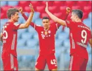 ?? AFP ?? Bayern Munich's Thomas Mueller (left) and Robert Lewandowsk­i celebrate their win over Moenchengl­adbach on Saturday. Bayern won their ninth straight Bundesliga title even before they took the field as Dortmund beat RB Leipig.