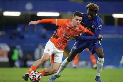  ?? Dennis/TGS Photo/Shuttersto­ck ?? Jake Daniels, playing for Blackpool Under-18s in February, shields the ball from Chelsea’s Luke Bailey Badley-Morgan. Photograph: Paul