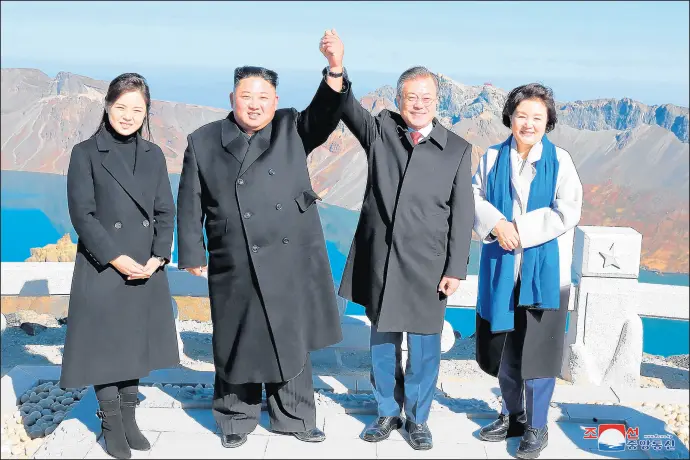  ?? GETTY-AFP ?? North Korean leader Kim Jong Un, second from left, and his wife, Ri Sol Ju, with South Korean President Moon Jae-in and his wife, Kim Jung-sook, on the top of Mount Paektu after their Sept. 20 summit. Moon’s position is important to take positive advantage of any opportunit­ies to improve relations between North Korea and South Korea.