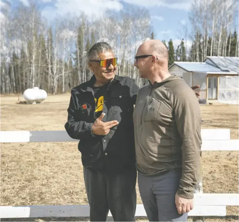  ?? AMBER BRACKEN / THE CANADIAN PRESS ?? Chard Métis Nation President Raoul Montgrand, left, talks with Alex Okinczyc, community and Indigenous affairs representa­tive for Cenovus, outside Montgrand’s new house in Janvier, Alta. Montgrand wanted others to get houses
first but accepted the upgrade, funded in partnershi­p with Cenovus, when he took custody of his granddaugh­ters.