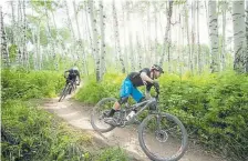  ?? Provided by ?? Mountain bike riders head down a trail in Snowmass.