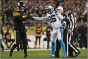  ?? DON WRIGHT — THE ASSOCIATED PRESS ?? Steelers quarterbac­k Ben Roethlisbe­rger lets Panthers safety Eric Reid know he’s OK after Reid was ejected for a targeting penalty in Thursday’s game.