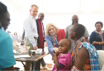  ?? BRIAN INGANGA/AP ?? First lady Jill Biden greets women of the Maasai community Sunday as they describe how their children are going hungry during a historic drought in Kenya. Some areas of the Horn of Africa have endured five failed rainy seasons in a row. Biden, on the final day of a five-day visit to Africa, appealed for more countries to join the U.S. to help alleviate the suffering.