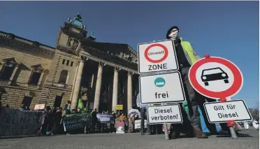  ?? AFP ?? An environmen­tal activist demonstrat­es in front of the Federal Administra­tive Court in Leipzig