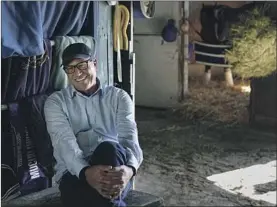  ?? Ashley Landis Associated Press ?? TRAINER Tim Yakteen relaxes at his barn at Santa Anita Park last week. Yakteen will train two of Bob Baffert’s horses running in Saturday’s Kentucky Derby.