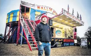  ??  ?? TV presenter Guy Martin in front of Ken Fox’s Wall of Death, which is coming to the Staffordsh­ire Moorlands this weekend.