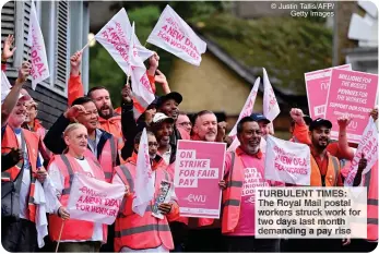  ?? ?? © Justin Tallis/AFP/
Getty Images
TURBULENT TIMES: The Royal Mail postal workers struck work for two days last month demanding a pay rise