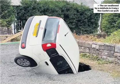  ??  ?? &gt; The car swallowed by a sinkhole in Craig y Nos Castle’s car park