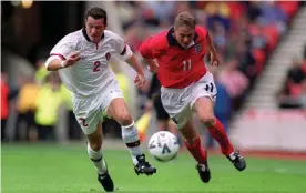  ?? Photograph: Action Images / Reuters ?? Steve Guppy attacks Belgium’s Eric Deflandre on his England debut in October 1999. Described by Kevin Keegan as a ‘left-sided David Beckham’, it was to be his only cap.