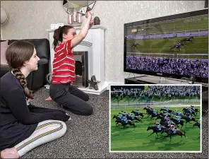  ??  ?? TUNING IN: Maisy and Lulu Byrne watch the Virtual Grand National