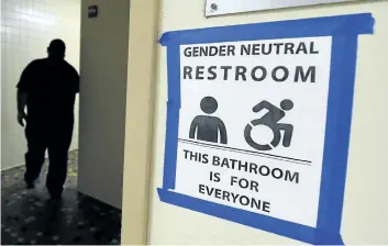  ?? GETTY IMAGES FILES ?? A sign posted outside the Santee High School’s gender neutral restrooms is seen at their campus in Los Angeles. The White House has overturned protection­s for transgende­r students.