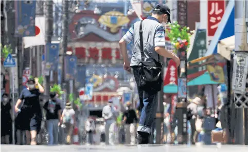  ?? REUTERS ?? Pedestrian­s walk during a heatwave at Sugamo district in Tokyo yesterday.