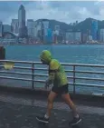  ??  ?? A man jogs along a promenade running along Victoria Harbour as Typhoon Haima approaches