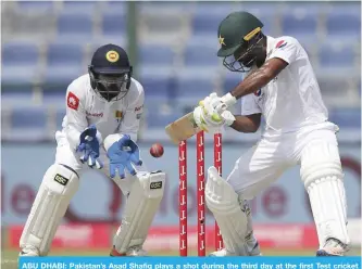  ?? — AP ?? ABU DHABI: Pakistan’s Asad Shafiq plays a shot during the third day at the first Test cricket match against Sri Lanka in Abu Dhabi, United Arab Emirates, yesterday.