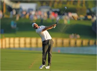  ?? AP PHOTO/CHAERLIE NEIBERGALL ?? Scottie Scheffler hits from the 18th fairway on the Players Stadium Course at TPC Sawgrass during the third round of The Players Championsh­ip on Saturday in Ponte Vedra Beach, Fla.