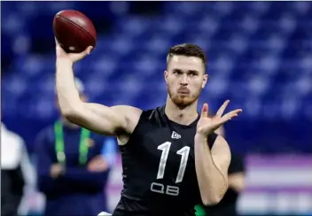  ?? AP Photo/Michael Conroy ?? In this Feb. 27 file photo, Oregon State quarterbac­k Jake Luton throws a pass at the NFL football scouting combine in Indianapol­is.