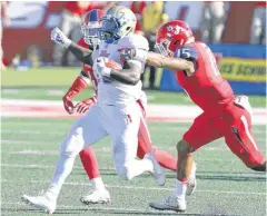  ?? [AP PHOTO] ?? Tulsa’s James Flanders runs past Fresno State’s Stratton Brown during Saturday’s game in Fresno, Calif.