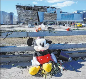  ?? Alexander Zemlianich­enko The Associated Press ?? Toys and flowers lie near the Crocus City Hall on the western outskirts of Moscow, Russia on Wednesday. The death toll in the attack rose to 143.