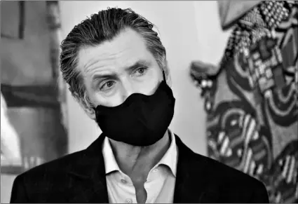  ?? AP Photo/Jeff Chiu, Pool ?? In this June 9 file photo, California Gov. Gavin Newsom wears a protective mask on his face while speaking to reporters at Miss Ollie’s restaurant during the coronaviru­s outbreak in Oakland, Calif.