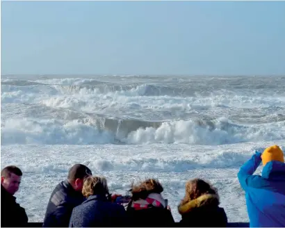  ?? AFP ?? People watch waves during the storm Carmen in Lacanau, southweste­rn France, on Monday. The French meteorolog­ic office is predicting 130km/h winds. —