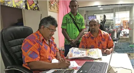  ?? Maraia Vula ?? From left (seated): Courts (Fiji) Limited Director of Marketing, Anil Senewiratn­e and Courts Retail Manager Benjamin Mohammed serve a customer at Courts Rodwell Road Branch on February 7, 2020. Photo: