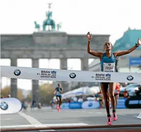  ??  ?? The Berlin Marathon ends under the Brandenbur­g Gate, a reminder of running’s place in political and cultural history.