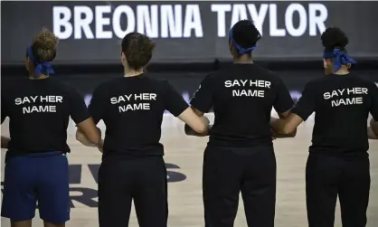  ?? Photograph: Phelan M Ebenhack/AP ?? Minnesota Lynx players lock arms during a moment of silence in honor of Breonna Taylor before a game against the Connecticu­t Sun last summer in the WNBA bubble in Bradenton, Florida.