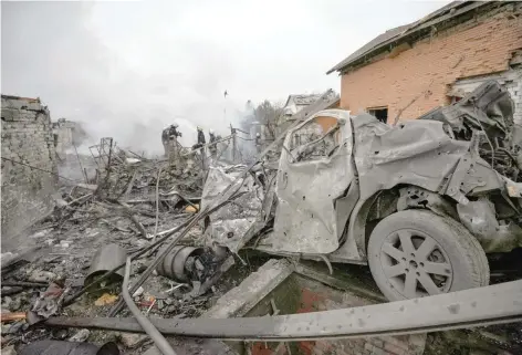  ?? — Reuters ?? Rescuers work at a site of private houses heavily damaged by a Russian missile strike, amid Russia’s attack in Dnipro, Ukraine, on Saturday.