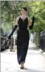  ?? CHRISTOPHE­R PLEDGER — THE ASSOCIATED PRESS FILE ?? Model Romilly Collins wears the black Givenchy dress made for actress Audrey Hepburn in the classic 1961 film “Breakfast at Tiffany’s” in central London.