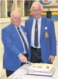  ??  ?? Piece of cake Former Scottish champion Alex Torrance, a past president of the Royal Caledonian Curling Club and director of Lanarkshir­e Ice Rink, cuts the celebratio­n cake with Jim Raeburn, LIR chairman