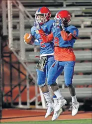 ?? [NATE BILLINGS/ THE OKLAHOMAN] ?? John Marshall's Bryce Stephens, left, celebrates a touchdown with his brother, Tim, during a recent game at Taft Stadium. Bryce, a wide receiver and defensive back, is being recruited by several Division I schools.