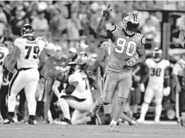  ?? Associated Press ?? Carolina Panthers' Julius Peppers (90) celebrates his sack of Philadelph­ia Eagles' Carson Wentz in the first half of an NFL football game Oct. 12 in Charlotte, N.C. Veteran DE Julius Peppers has six and a half sacks in six games since his return to...