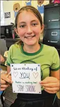  ??  ?? Olivia Gravette displays a card made for a Hurricane Harvey evacuee as part of the service project.