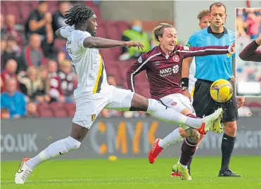  ?? ?? Livingston’s Ayo Obiley and Hearts’ Barrie Mckay challenge for possession