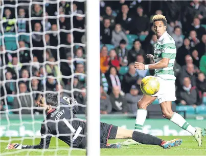  ?? Picture: PA. ?? Scott Sinclair clips the ball past Tomas Cerny to put Celtic in front.