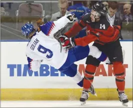  ?? The Canadian Press ?? Team Canada forward Maxime Comtois, right, checks Team Slovakia’s Andrej Golian during IIHF World Junior Championsh­ip pre-tournament action in Victoria on Friday.