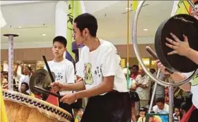  ??  ?? Lion dance drummer, Adam Firdaus Mohd Nur (centre), fell in love with the art the first time he was introduced to it.