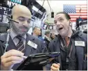  ?? Richard Drew ?? The Associated Press Traders Fred Demarco, left, and Tommy Kalikas at the New York Stock Exchange on Friday. U.S. stock indexes rallied to end a turbulent week.