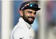  ??  ?? Still calm: India’s captain Virat Kohli can still afford to smile after yesterday’s opening day. — AP