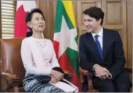  ?? CP PHOTO ADRIAN WYLD ?? Aung San Suu Kyi, the civilian leader of Myanmar and an honorary Canadian citizen, shares a laugh Wednesday with Prime Minister Justin Trudeau in his office on Parliament Hill.
