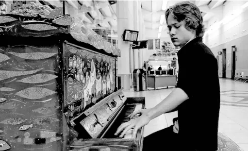  ?? CONTRIBUTE­D PHOTOS ?? #Comeplaywi­thmenl has created a community project where they place unwanted pianos in public places for people to enjoy. Noah Hamilton of Deer Lake, NL, is seen here taking advantage of the project.