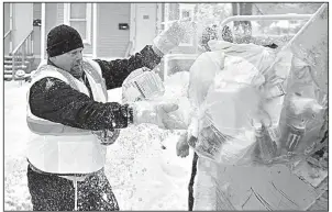  ?? AP/The Syracuse Newspapers/SCOTT SCHILD ?? Sanitation worker Paul Fairbanks collects garbage in the snow and cold Friday in Syracuse, N.Y., as wind chills plunged as low as minus 25 degrees.