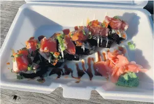  ?? MATTHEW KORFHAGE/STAFF ?? The bloodmoon sushi roll at Vang’s food truck, with shrimp tempura, avocado, and tuna poke.